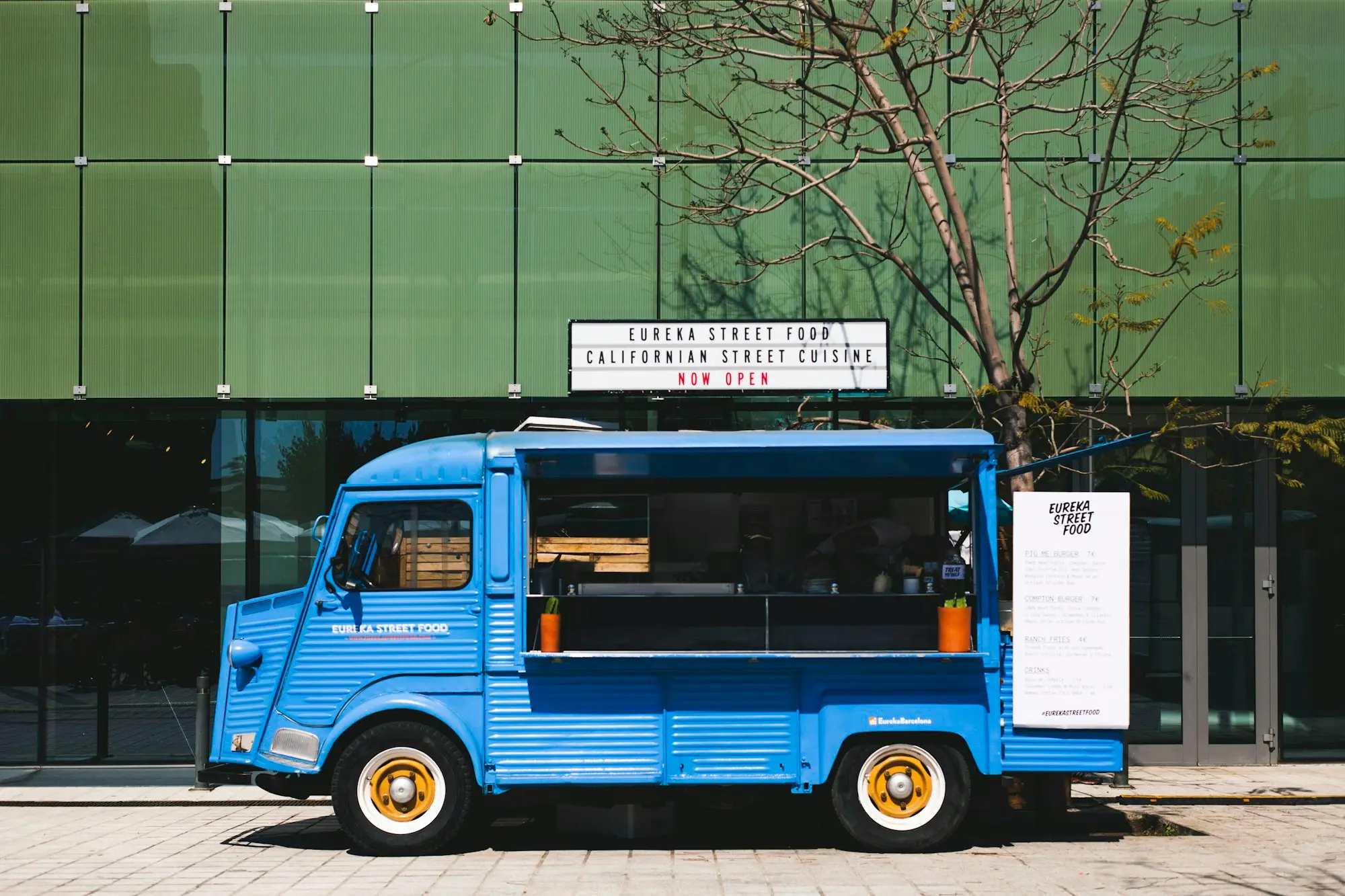 Blue vehicle parked up, the kind of modern car a business might switch to electric